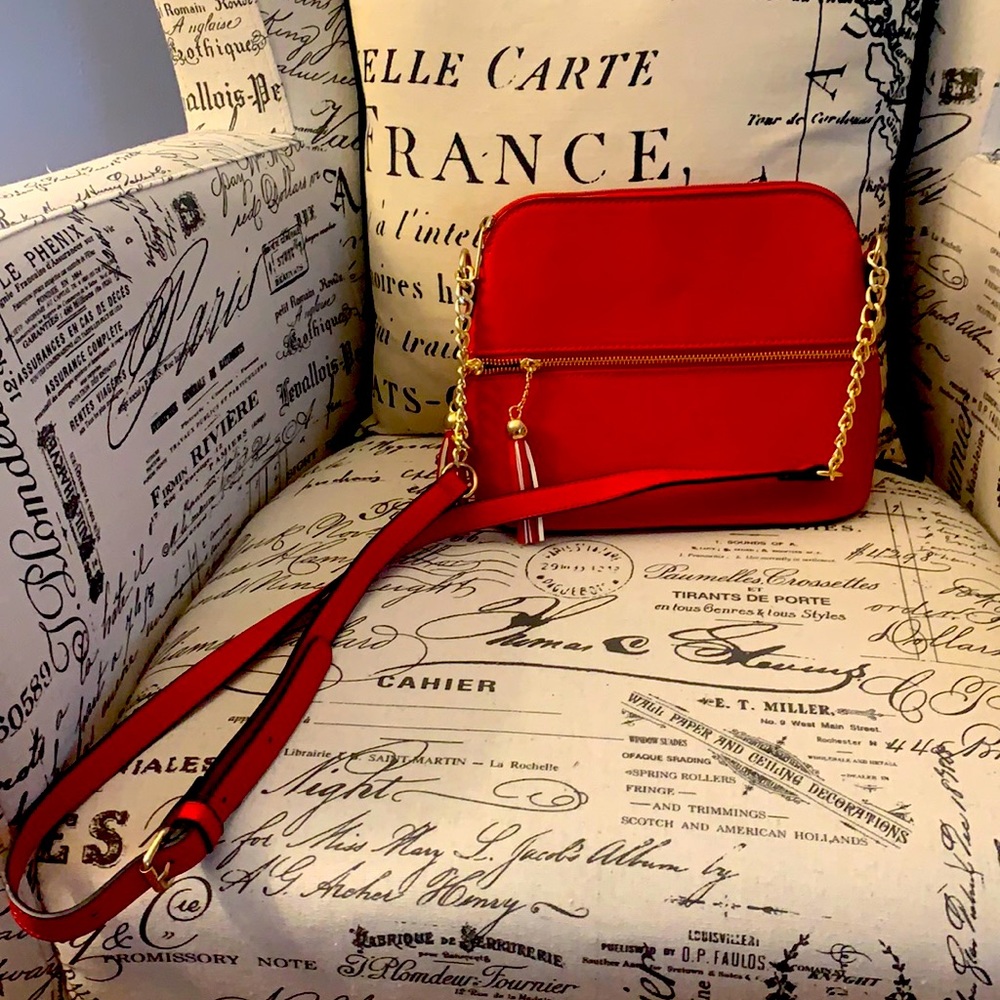 Adorable red crossbody bag with cute gold details.